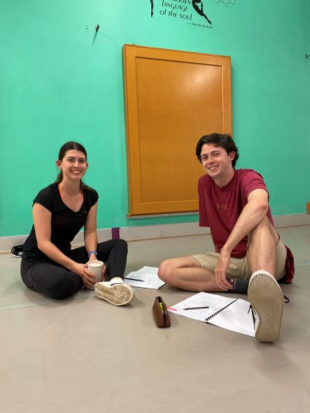 Actors Julia and Tim smiling for the camera in rehearsals