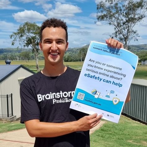 Brainstorm Productions actor Raphael is holding a poster that says