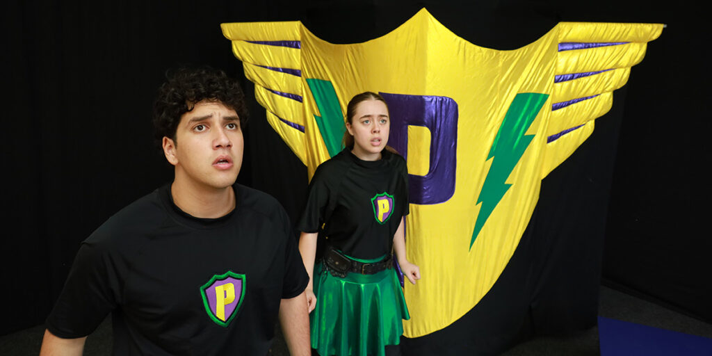 Two young Brainstorm Productions actors looking concerned towards something in the distance, during a performance of the primary school show The Protectors