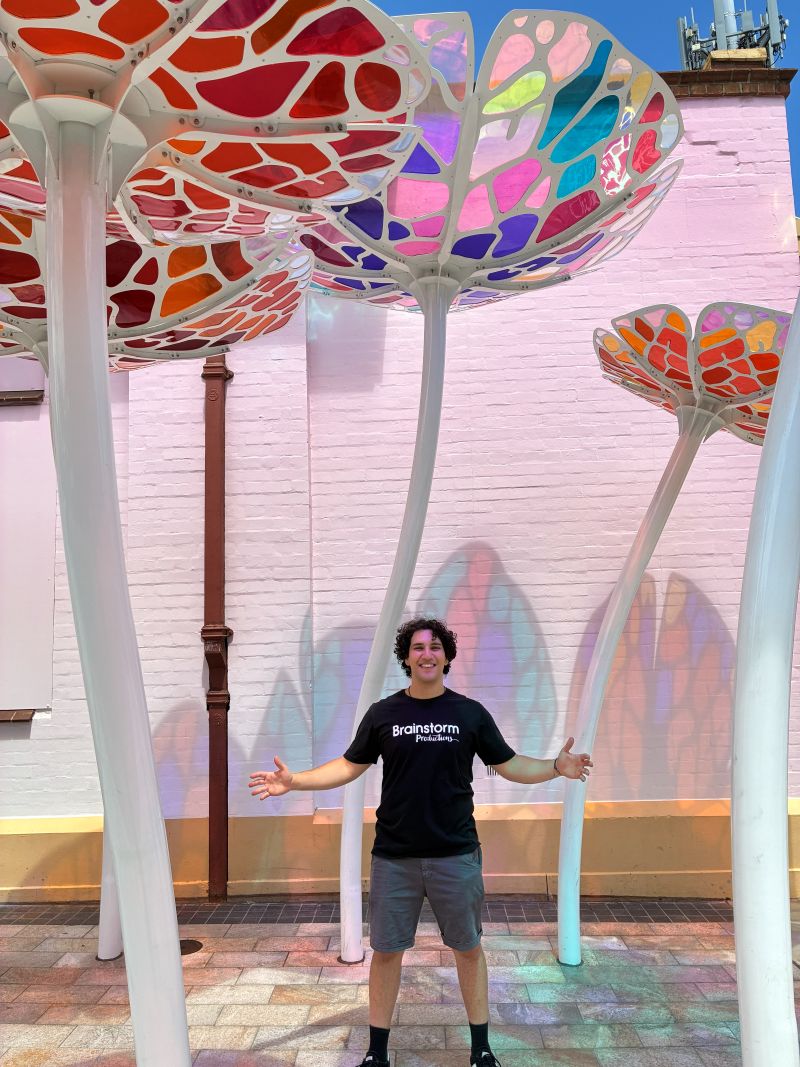 A Brainstorm productions actor under an art installation in Glenelg Adelaide while on tour